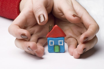small house between hands