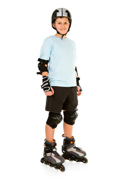 Young, happy roller boy in protection kit standing and looking