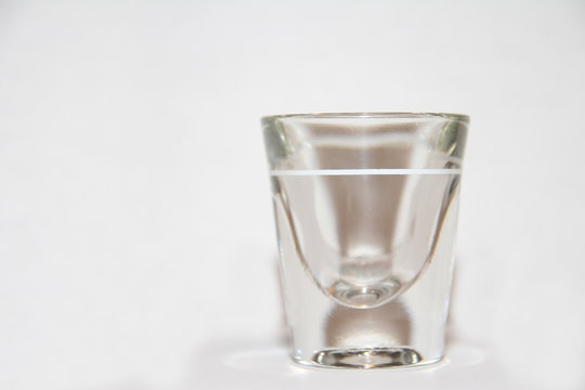 Shot Glass with white backround and slight reflection at base
