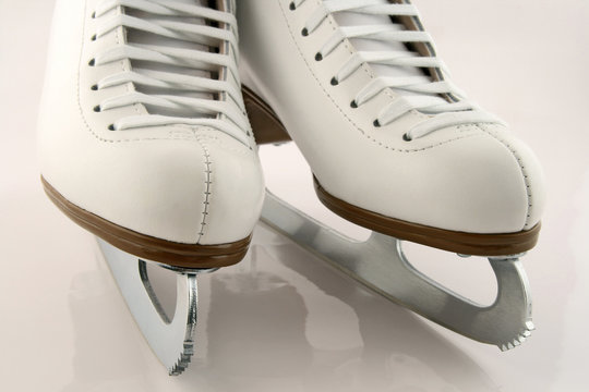 A pair of elegant white figure skates.