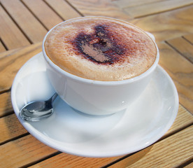 a cup of coffee over a wooden table