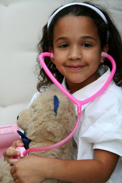 Young Girl Plays Doctor Or Nurse With Stuffed Animal