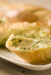 close-up of baguette with herb butter, soft focus