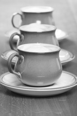  black and white coffee cups in a row.