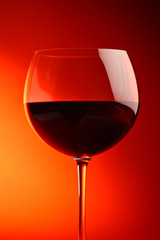 Wine glass against red background