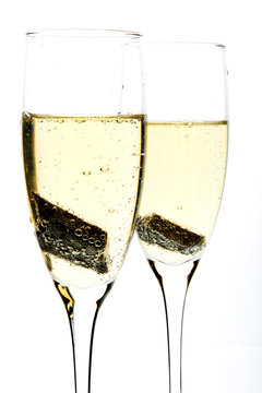 Glass of champagne with piece of chocolate inside