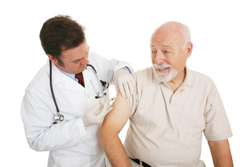 Senior man getting a flu shot from his doctor.  Isolated 