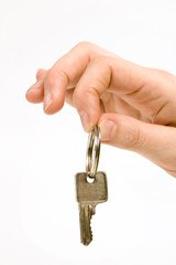 close up of a person's hand, handing over a key.  