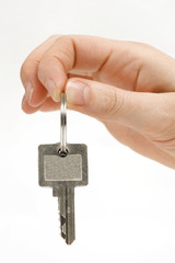 close up of a person's hand handing over the key. 