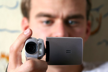 Fototapeta premium young man with digital video camera