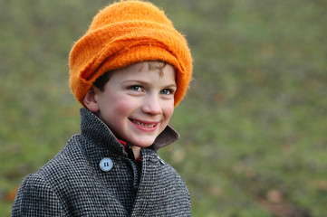 close-up portrait of boy in orange hat