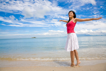 Fototapeta na wymiar beautiful red top girl & white skirt stretching on the beach