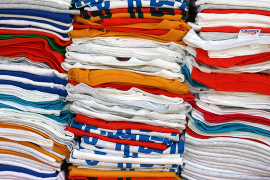 stacked t-shirts in many colors