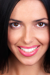 Smiling  young woman face. Over white background.