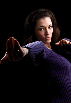 a young girl carefully mastering kung- fu