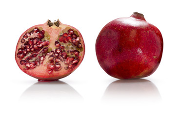 Whole pomegranate and half a pomegranate isolated on white