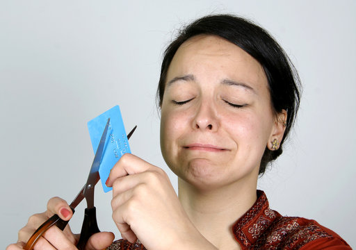 lady cutting up her credit card in despair