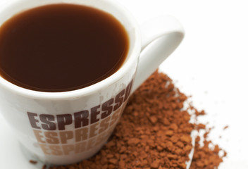 Closeup of espresso coffee cup with instant coffee granules 