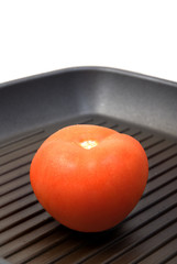 fresh tomato in frying pan close up