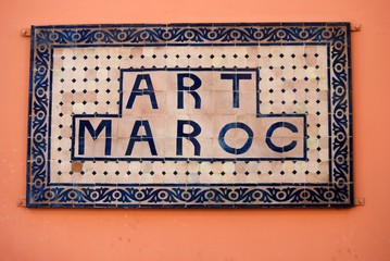 old sign-board on the orange back-ground of wall