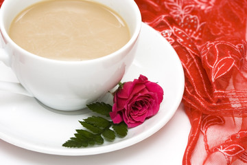 white cup of coffee with red roses