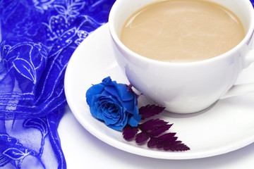 white cup of coffee with blue rose