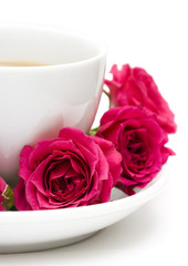 white cup of coffee with red roses