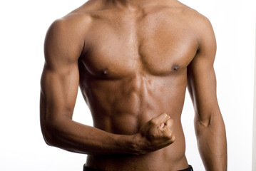 a muscular model is posing against white background