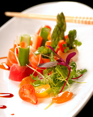 Variety of fresh japanese sashimi on a white plate