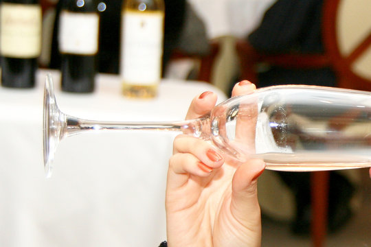 Female hand hanging glass of wine