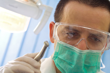 Male dentist with drill - shallow DOF