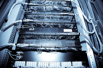 A shot of network equipment in a data center (in blue tone)