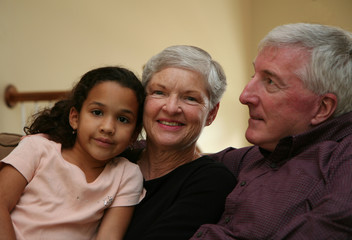 Fototapeta na wymiar Happy Senior Couple smiling with grandchild