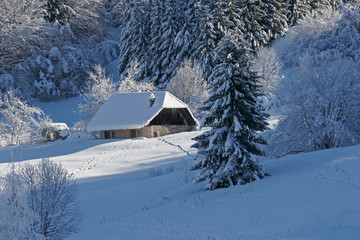 Landscape of mountain showing a house under snow