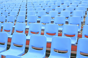 Fototapeta premium Empty blue bleachers in an open air environment