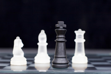 The black king comes under attack in a game of chess