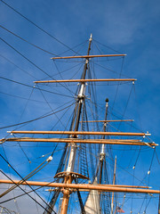 Fototapeta premium Three masts and tackle of a tallship against blue sky