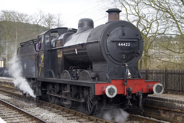 Obraz na płótnie Canvas A steam engine pulls into the station