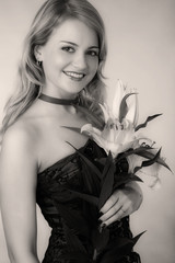 young blond woman with pink lily, black and white, sepia