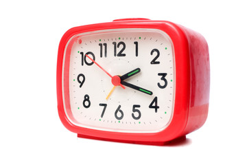 Old red alarm clock on a white background