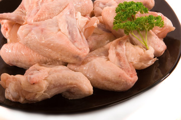 Raw Chicken Wings on Black Plate