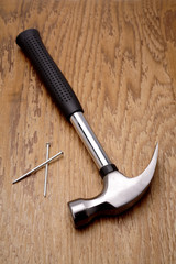 Hammer and nails on wooden panel