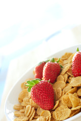 Fresh red strawberries and breakfast cereal in a white bowl 