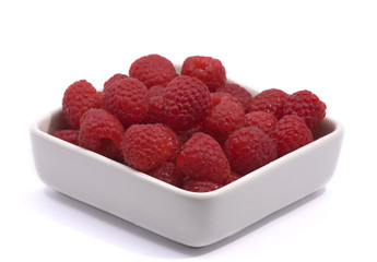 Organic raspberries in ceramic bowl