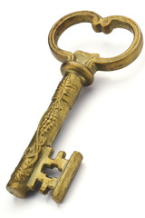 a golden ornamented key on white background