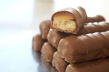 Tower of thin chocolate bars with one broken bar