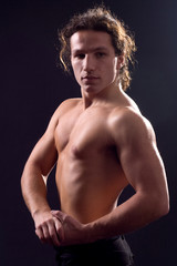 Fototapeta premium Portrait of athlete on black.