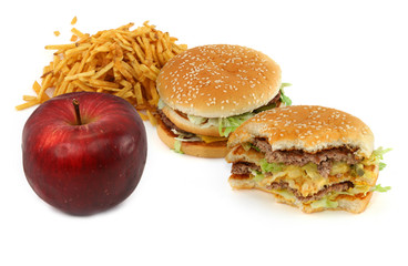 junk food and apple against white background, 