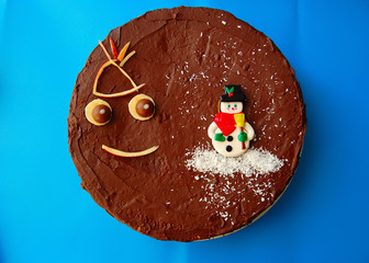 snow man on a chocolate cake