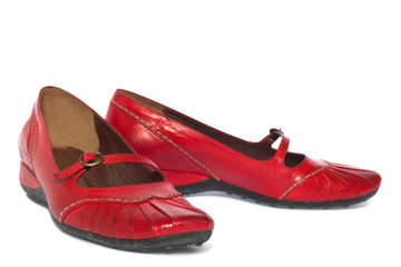 pair of red casual women's shoes on white